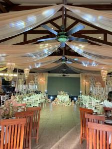 a banquet hall with tables and chairs and a ceiling at FIG Sunset View Resort in Siquijor