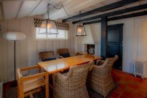 a dining room with a wooden table and chairs at Trysilfjellet Nord 1111B in Trysil +13 photos