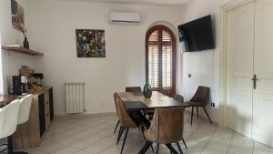 a dining room with a table and chairs at Addaura Paradise House in Palermo