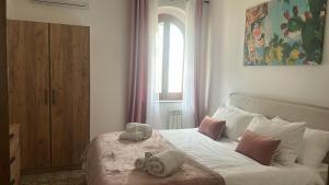 a bedroom with a bed with two stuffed animals on it at Addaura Paradise House in Palermo +21 photos