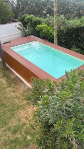 a large swimming pool with a wooden deck and sidx sidx sidx at Addaura Paradise House in Palermo