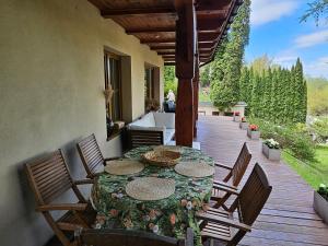 a patio with a table and chairs on a deck at Dom u Profesora in Kazimierz Dolny
