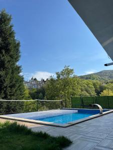 a swimming pool in a backyard with a view of the mountains at Yeşilyurt villa in Sapanca