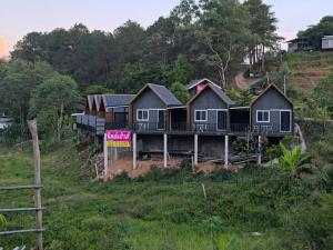 a row of houses on the side of a hill at Chill House Khaokho in Khao Kho +4 photos