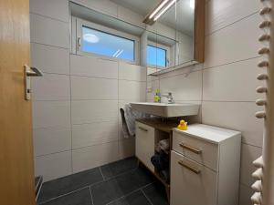 a bathroom with a sink and a mirror at Ferienwohnung Heid in Rettenberg