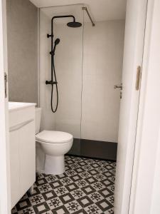 a bathroom with a toilet and a shower at Quinta Farm Stay - Silence and Nature Retreat in Lousã