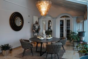 a dining room with a table and chairs and a chandelier at Hotel Burgwirt in Deggendorf