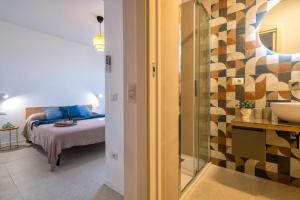 a bedroom with a bed and a glass wall at Opera Rooms Alghero in Alghero