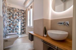 a bathroom with a sink and a toilet at Opera Rooms Alghero in Alghero