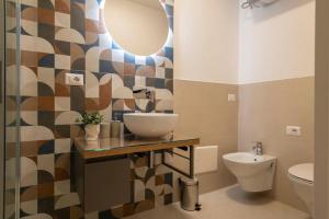 a bathroom with a sink and a toilet at Opera Rooms Alghero in Alghero