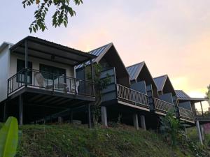 a row of houses with solar panels on their balconies at Chill House Khaokho in Khao Kho