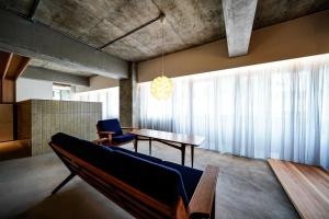 a living room with a couch and a table at Alternest Kamakura in Kamakura