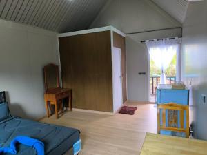 a bedroom with a bed and a wooden floor at Chill House Khaokho in Khao Kho