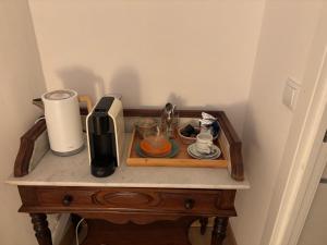 a table with a coffee maker on top of it at Quinta Farm Stay - Silence and Nature Retreat in Lousã