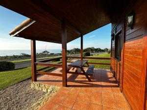 a picnic bench on a porch of a building at Ericeira Camping in Ericeira