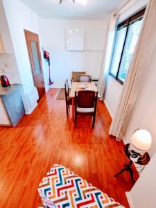 a living room with a table and a dining room at Apartment Green Garden in Sarajevo