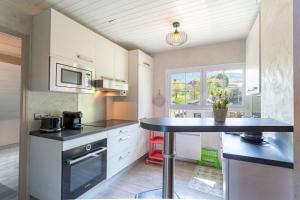a kitchen with a table and a microwave at Waterfront in Lugrin