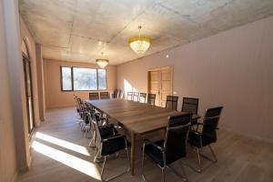 a conference room with a large wooden table and chairs at Hotel Chateau Ochia in Koromkhet'i