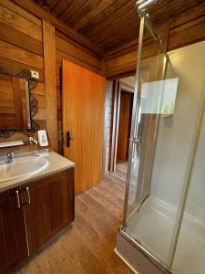 a bathroom with a shower and a sink at Ericeira Camping in Ericeira