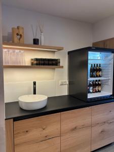 a kitchen with a counter with a sink and a refrigerator at Gasthaus Kerber in Fürstenstein +33 photos