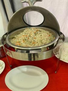 a pot of food sitting on a table next to a plate at Thi Long Phụng Hotel in Phú Quốc
