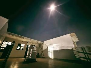 a light in a building with a ladder in the dark at The Bel - Monte Stays in Panchkula