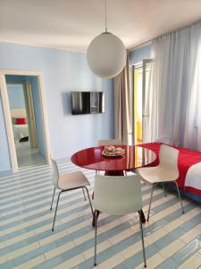 a dining room with a table and chairs and a bed at Case Borgo Vacanze in Letojanni
