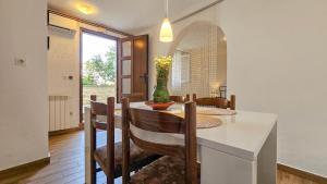 a kitchen and dining room with a table and chairs at Ivanka Studio in Dajla +30 photos