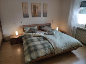 a bedroom with a large bed with two night stands at Ferienwohnung Klaus in Ebermannstadt