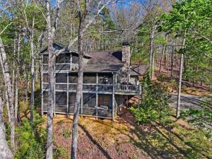 a home with a wrap around deck in the woods at Not Your Average Bear Hot Tub in Blue Ridge