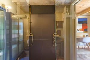 a bathroom with a shower with a glass door at Eclectic Monte Laginha Alentejo in Aldeia do Cano +22 photos