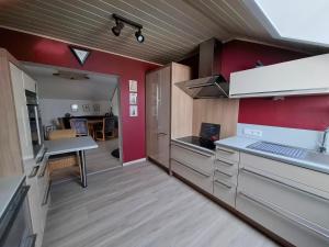 a kitchen with red walls and a counter top at Ferienwohnung Charbi in Simmern