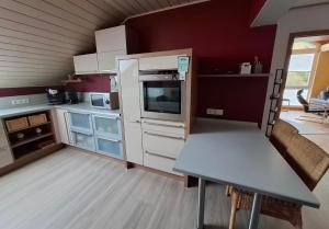 a kitchen with white appliances and a table in it at Ferienwohnung Charbi in Simmern +12 photos