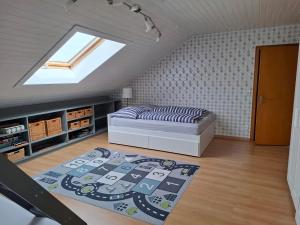 a bedroom with a bed and a rug on the floor at Ferienwohnung Charbi in Simmern