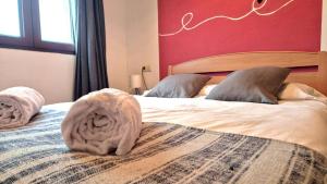a bedroom with two beds with towels on them at Casa Senderuela by CARDI Suites in Valdelinares