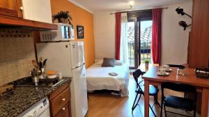 a small kitchen with a small bed in a room at Casa Senderuela by CARDI Suites in Valdelinares +10 photos