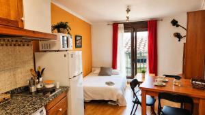 a small kitchen with a small bed in a room at Casa Senderuela by CARDI Suites in Valdelinares
