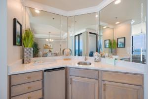 a bathroom with a sink and a large mirror at Phoenix IX 707 in Orange Beach