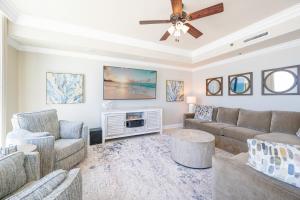 a living room with couches and a ceiling fan at Phoenix IX 707 in Orange Beach +37 photos