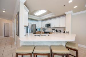 a kitchen with white cabinets and a large island at Phoenix IX 707 in Orange Beach