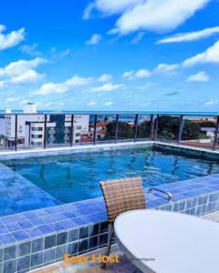 a swimming pool on the roof of a building at Uno Flats - By EasyHost in Tambaú