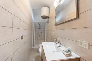 a bathroom with a sink and a toilet and a mirror at Private Green Oasis - Terrace - Happy Rentals in Tenno