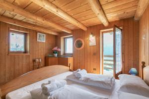 a bedroom with two beds in a room with wooden walls at Private Green Oasis - Terrace - Happy Rentals in Tenno