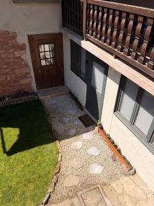 a porch of a house with a wooden door at Chez l'Alsacienne in Andlau