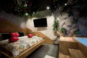 a bedroom with a bed with red apples on it at Navigator Apartment in Bijeljina +46 photos