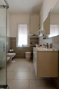 a bathroom with a sink and a toilet at Gold Apartment in Ferrara +105 photos