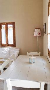 a living room with a white table and chairs at Anerada Houses - Seaviews Above Egremni in Lefkada in Athani