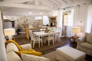 a kitchen and living room with a table and chairs at Casas de Selim in Arcos de Valdevez