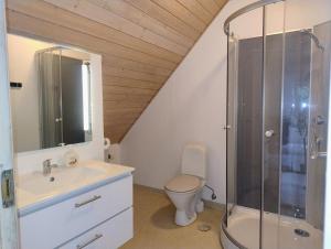 a bathroom with a toilet and a sink and a shower at Henne Station, Midtiby B & B in Henne