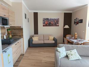 a living room with a couch and a table at alma713 apartman in Zalakaros